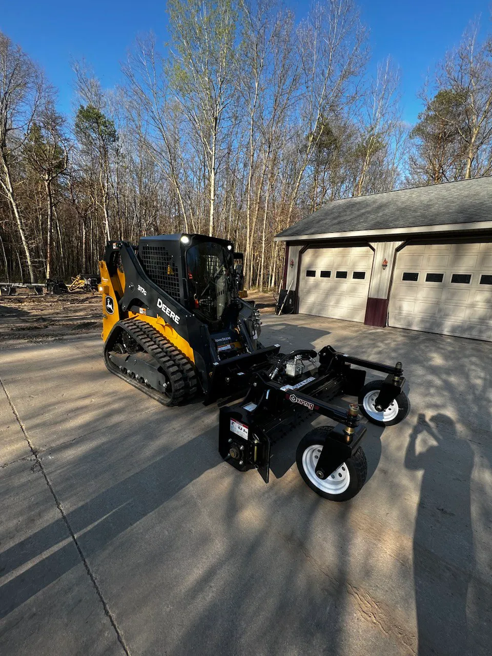 SkidSteer with Harley Rake attached.