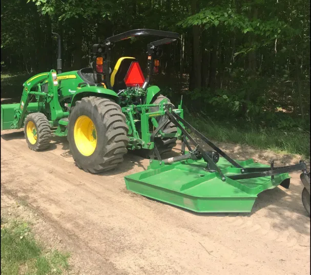 Compact Tractor with a brush hog attachement.