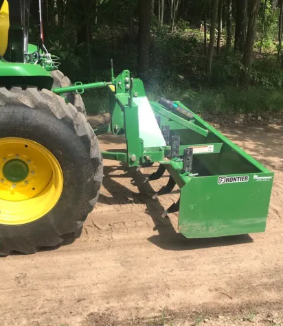 Compact Tractor with a grader attachement.