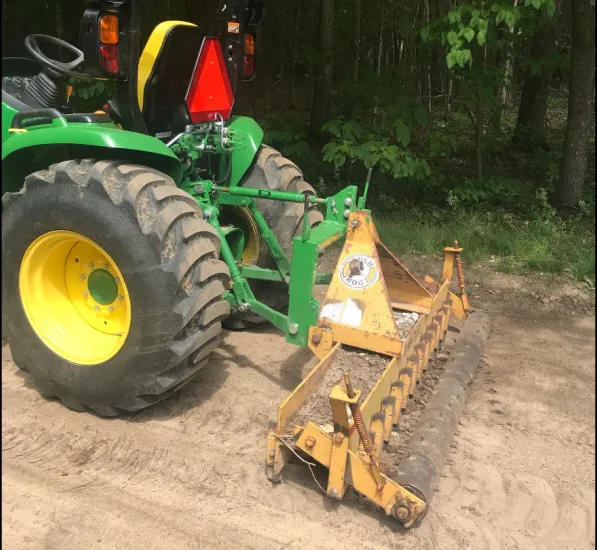 Compact Tractor with a yard rake attachement.